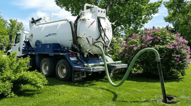 Professional vacuum truck performing residential drainage and septic maintenance in Tampa, FL