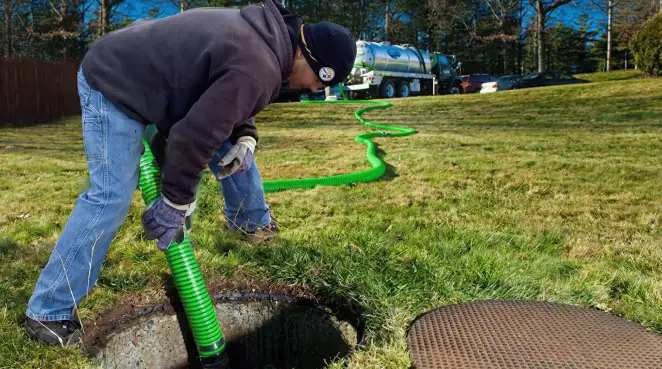Service technician performing residential septic pumping and drainage maintenance in Tampa, FL